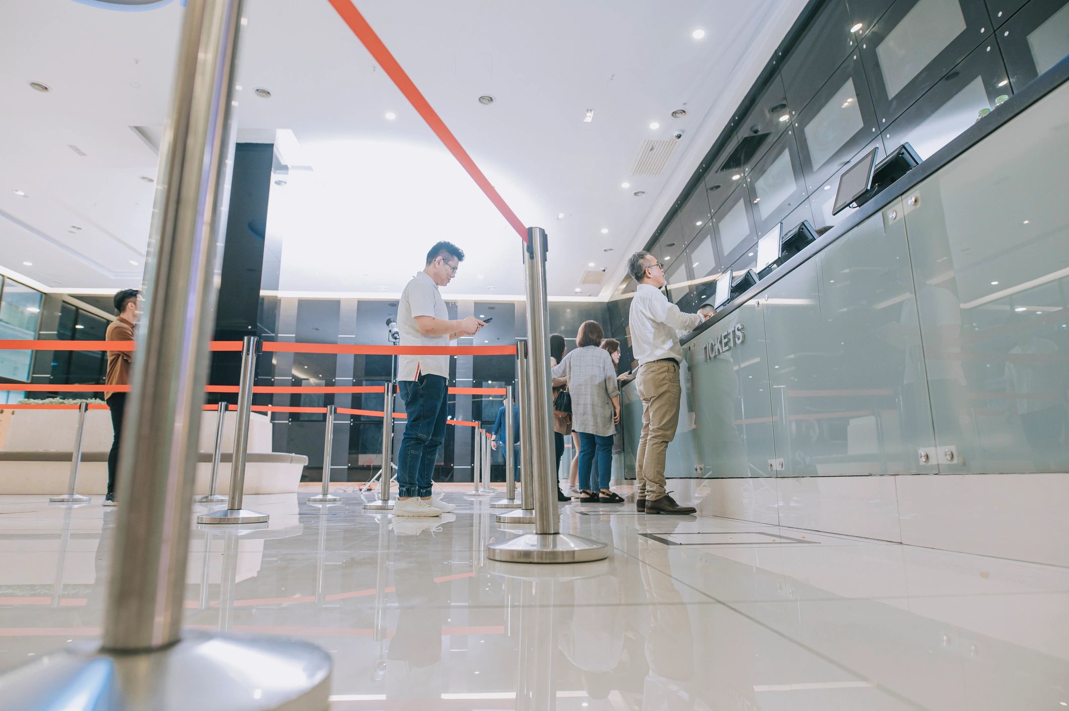 Guests waiting in line at a high-volume ticket counter