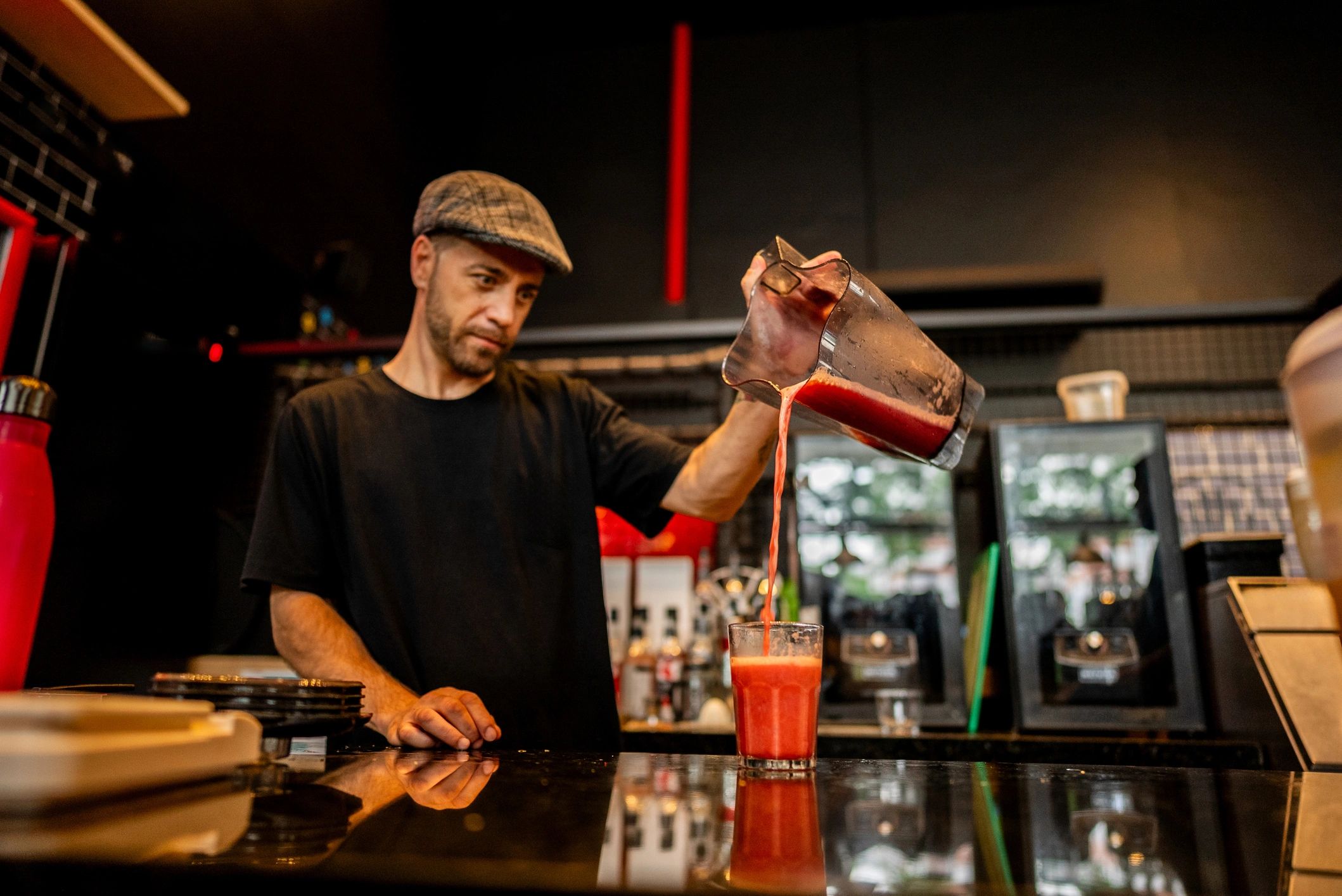 Bartender working quickly behind a busy bar