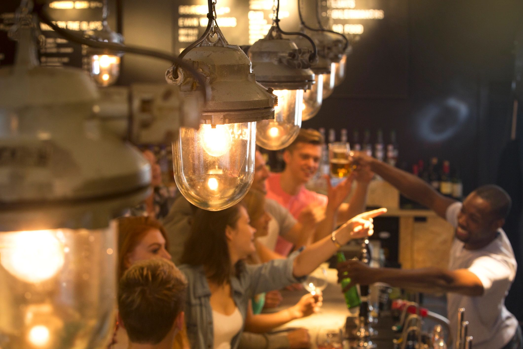 Guests ordering drinks at a busy bar