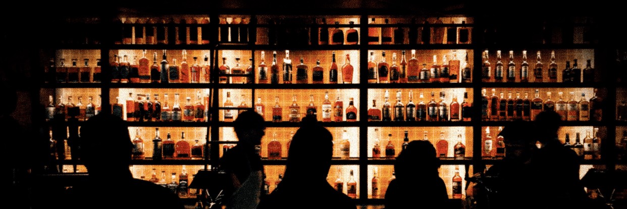 Moody bar interior with glowing back-bar bottles — SmartTab